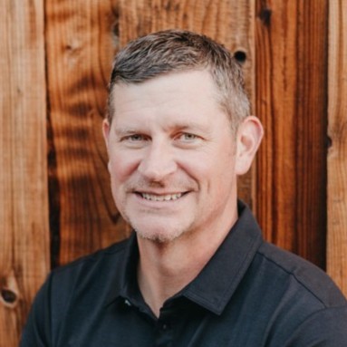 Brett Coin, Chief Transformation Officer at Findem seen posing for a photo in a black color shirt